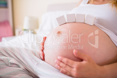 Pregnant woman with paper block on belly