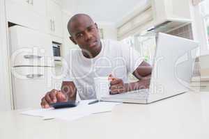 Portrait of a man working and using his laptop and looking at ca