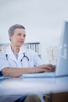 Female doctor using her laptop computer