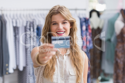 A pretty blonde woman showing her credit cards