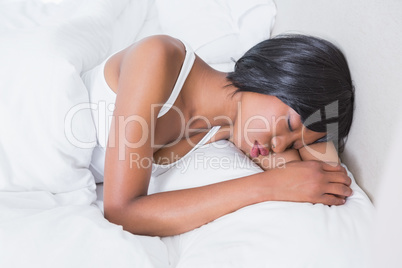 Pretty brunette sleeping in her bed