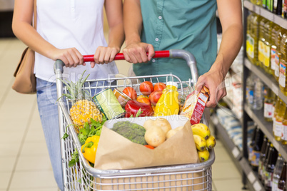 Bright couple buying food products