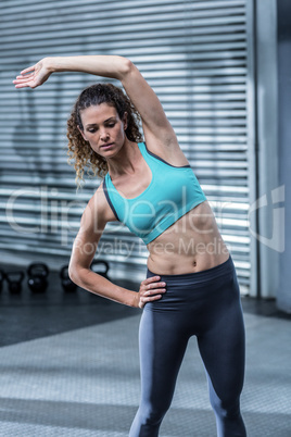 Muscular woman stretching her body