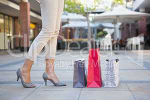 Woman standing next to her shopping bags