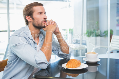 Young thoughtful man looking in the distance