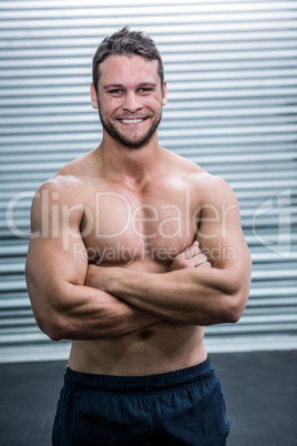 Portrait of smiling muscular man looking at camera