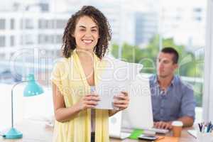 Smiling businesswoman holding a notebook