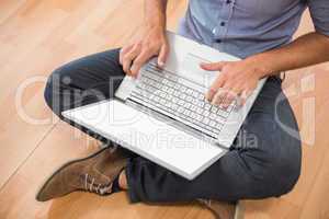 Young creative businessman working on laptop