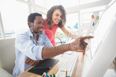 Two creative business colleagues watching the computer