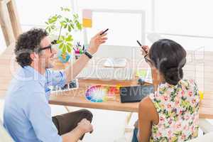 Smiling business coworkers pointing screen of computer