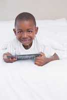 Portrait of a beautiful little boy using digital tablet