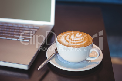Close-up of laptop and coffee on table Close-up of laptop and coffee on table