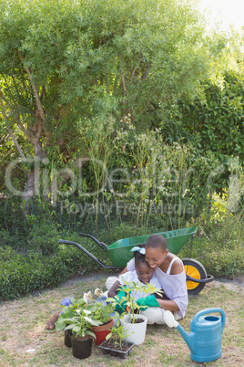 Happy smiling mother gardening with her daughter