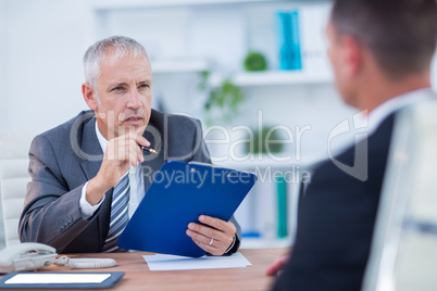 Two businessmen speaking and working