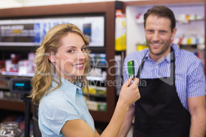Woman at cash register paying with credit card