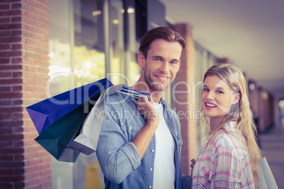 Portrait of a happy couple with shopping bags