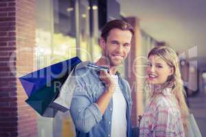 Portrait of a happy couple with shopping bags