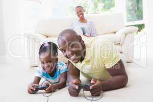 Portrait of a happy smiling father playing with her daughter at