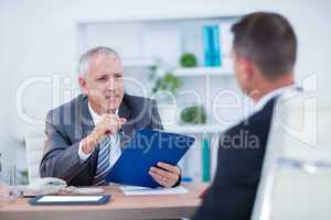 Two businessmen sitting and speaking and working