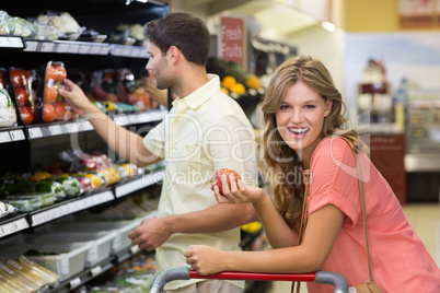 Portrait of smiling pretty blonde woman buying food products