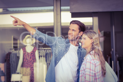 Happy couples looking and pointing far away