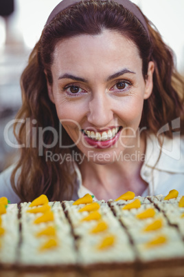 Pretty brunette looking at pastries