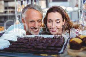 Happy couple looking at cakes