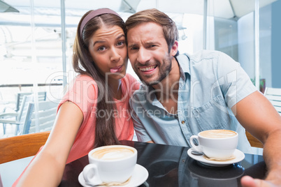 Young couple making selfie with weird faces