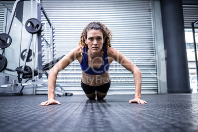 Muscular woman doing push-ups