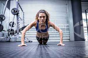 Muscular woman doing push-ups