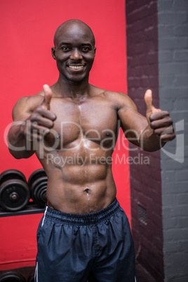 Young Bodybuilder standing in front of the camera with his thumb