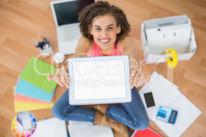 Young creative businesswoman showing her tablet