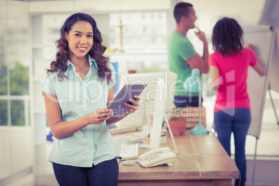 Smiling young woman using digital tablet