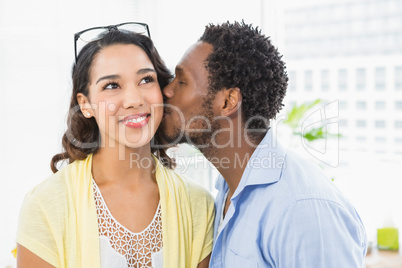 Portrait of a man kissing his colleague