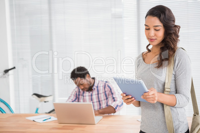 Young business people holding a tablet