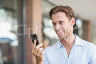 A happy smiling man looking at the phone