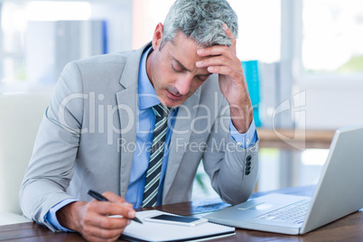 Irritated businessman trying to work