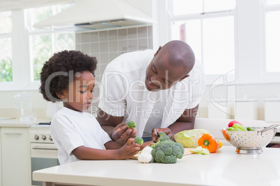 Little boy cooking with his father