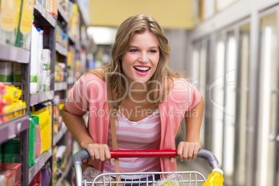 Smiling pretty blonde woman buying a products