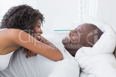 Happy smiling couple in bed
