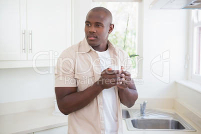 A man taking a glass and drinking tea