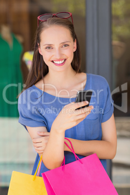 Happy woman sending a text message