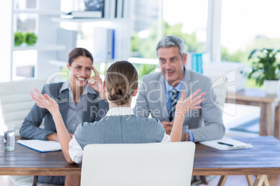 Business people interviewing young businesswoman