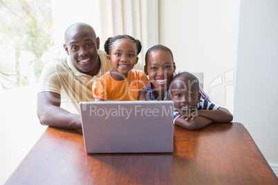 Happy smiling family using laptop