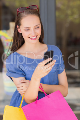 Happy woman sending a text message