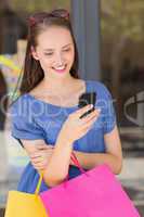 Happy woman sending a text message