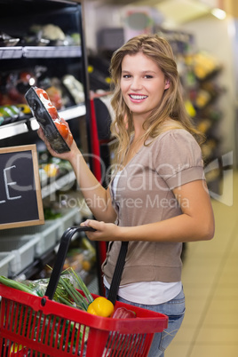 Portrait of smiling pretty blonde woman buying products