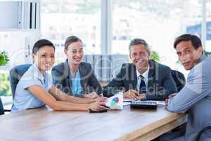 Business people looking at camera during meeting