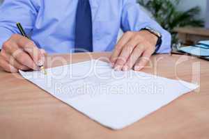 Businessman signing a contract in the office