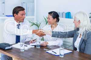 Business people shake hands during meeting